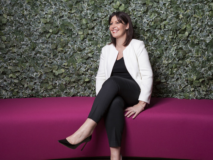 Janette Martin sitting on a pink bench.