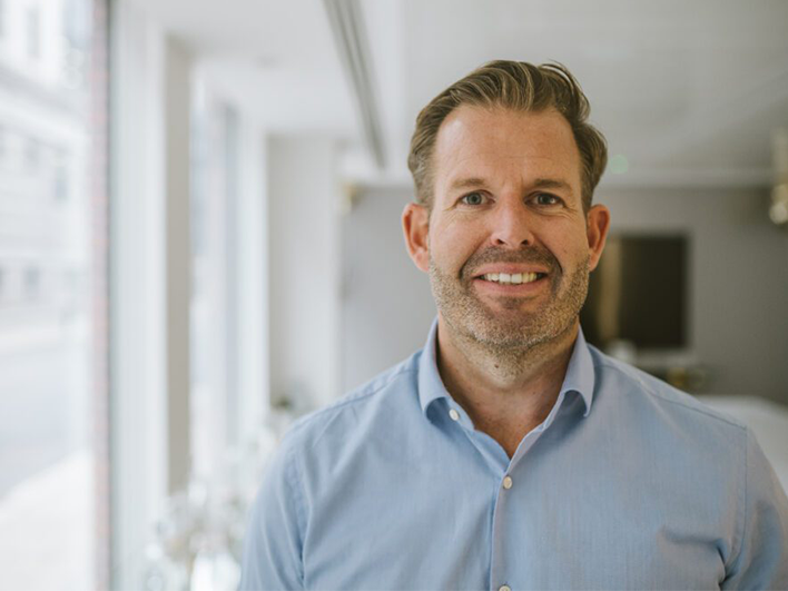 headshot image of Acora's CEO, David Rabson, smiling at camera.
